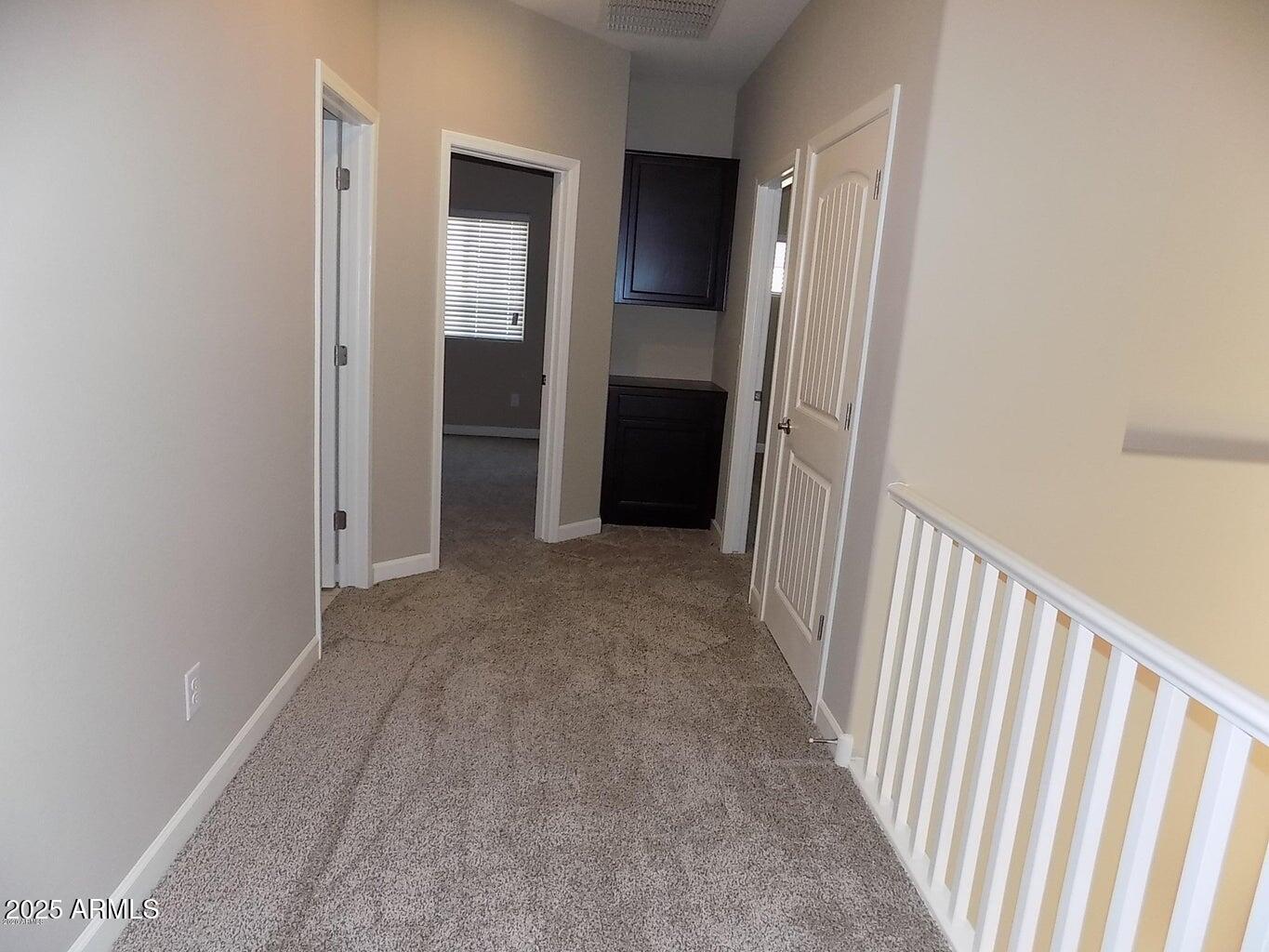 1367 South Country Club Drive, Unit 1076 Mesa, AZ 85210 - Photo 21 of 33 a view of a hallway with wooden floor and a bathroom