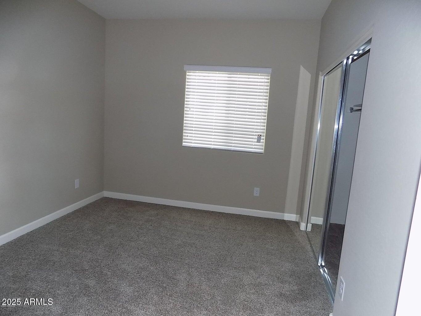 1367 South Country Club Drive, Unit 1076 Mesa, AZ 85210 - Photo 23 of 33 an empty room with a window