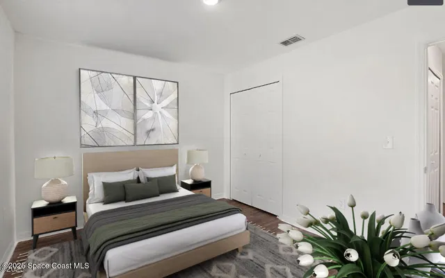 a bedroom with a bed and a potted plant