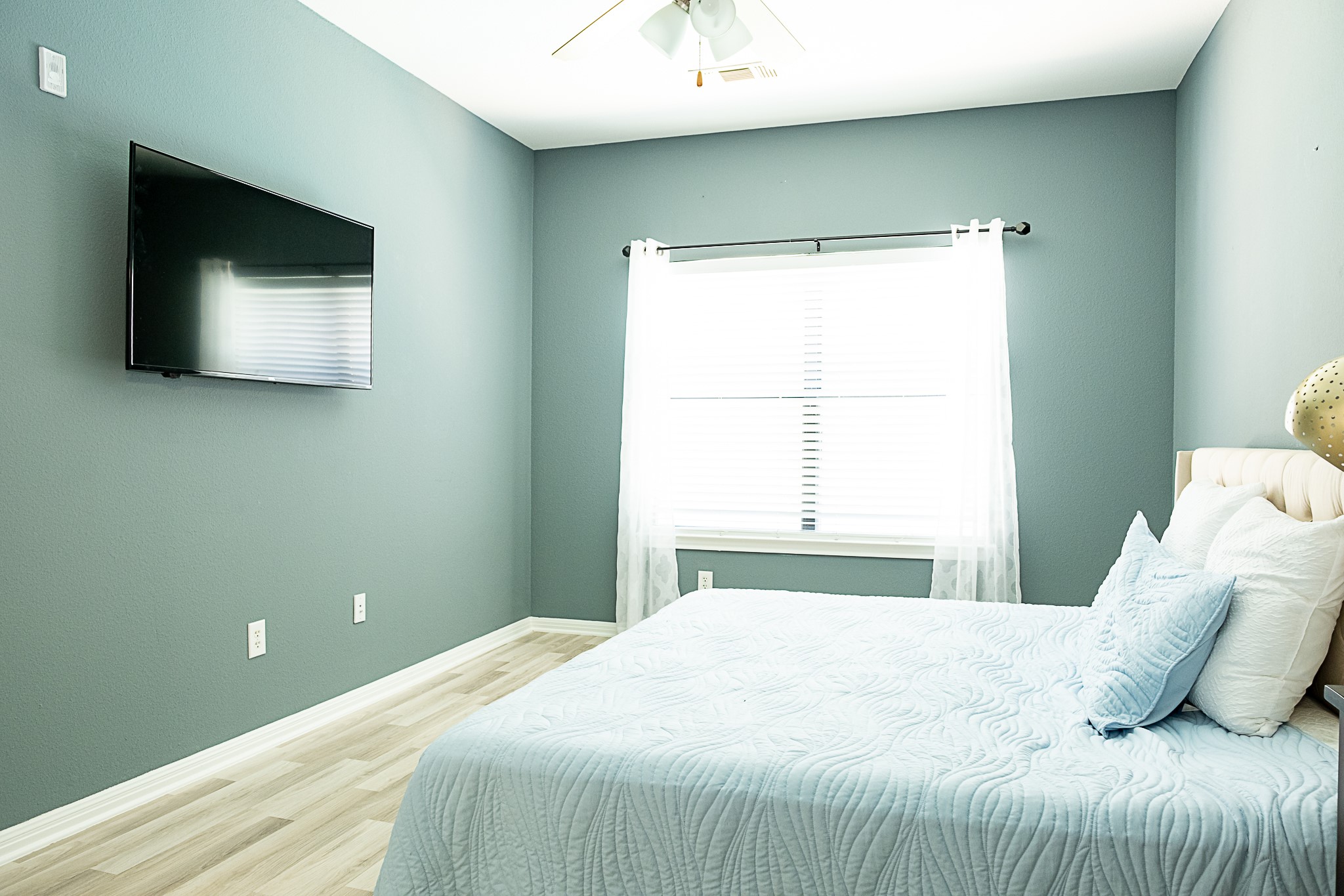 2502 Leon Street, Unit 309 Austin, TX 78705 - Photo 15 of 19 a bedroom with a bed and a flat screen tv