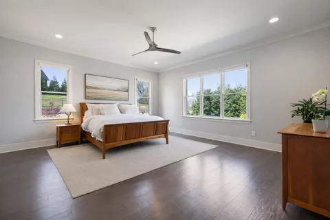 a bedroom with a bed lamp and window