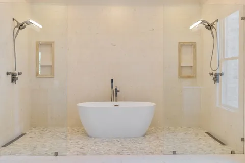 a white bath tub sitting next to a white sink