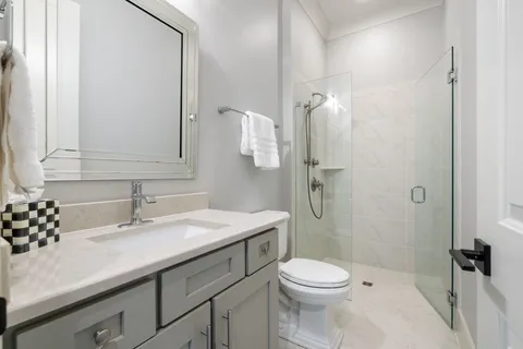 a bathroom with a sink toilet and shower