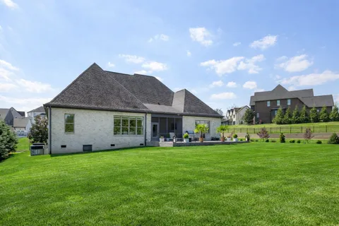 a view of a house with a yard and sitting area