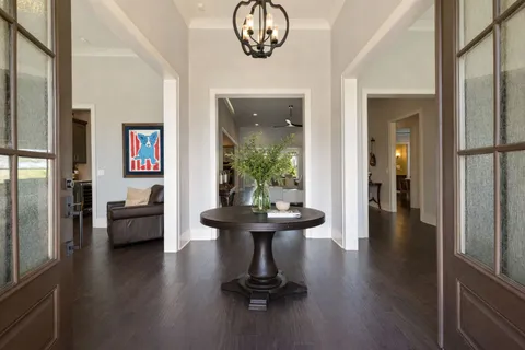 a living room with furniture and a large mirror