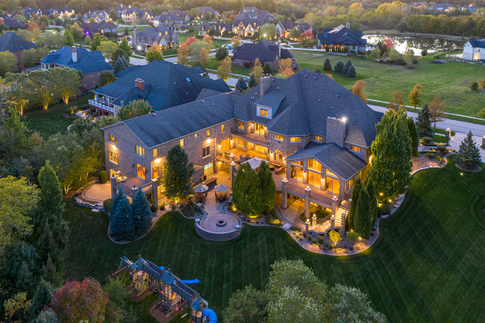 an aerial view of residential houses with outdoor space and swimming pool