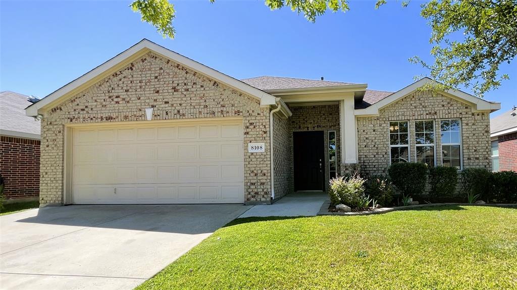 a view of a house with potted plants