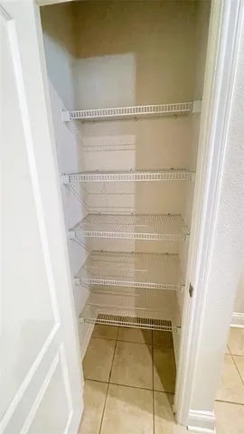 a view of livingroom and chandelier with a window
