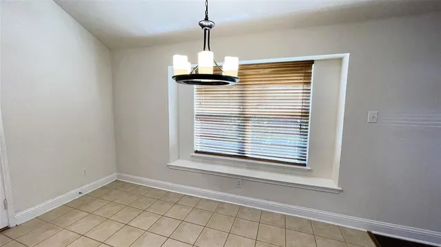 a view of a kitchen with wooden floor and a ceiling fan