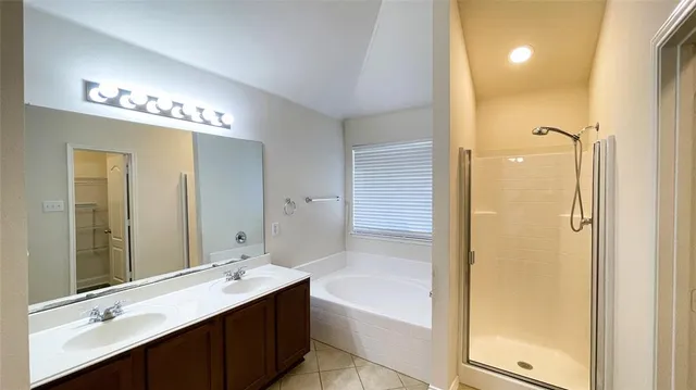 a bathroom with a white bath tub and a window