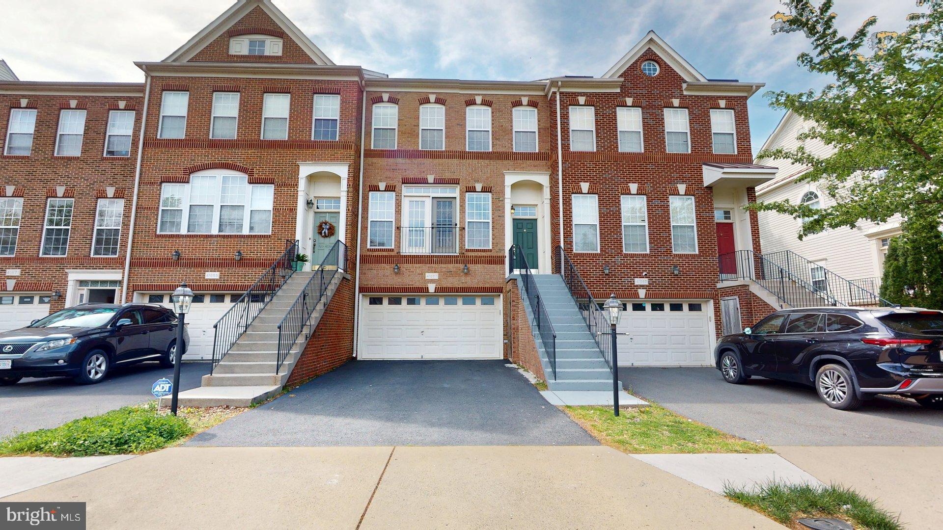 a view of a car park in front of a brick house