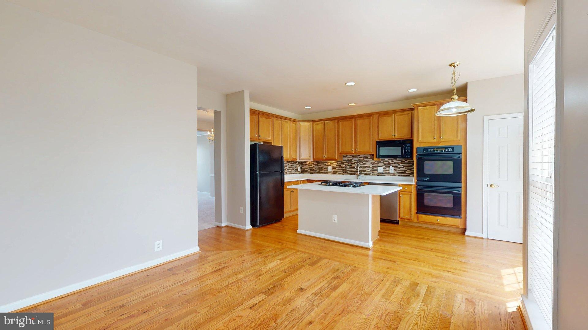 41867 Cinnabar Square Aldie, VA 20105 - Photo 12 of 26 a kitchen with stainless steel appliances granite countertop a refrigerator and a sink