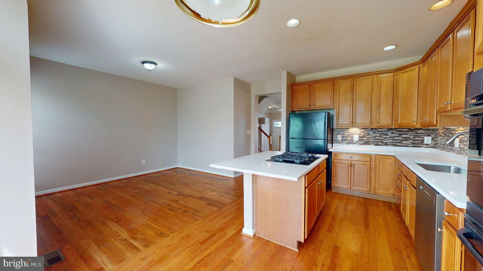 41867 Cinnabar Square Aldie, VA 20105 - Photo 10 of 26 a kitchen with a stove a sink and a refrigerator