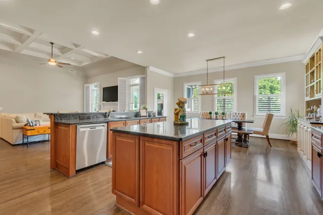 a dining room with furniture a chandelier and wooden floor