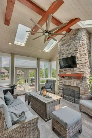 a bathroom with a bathtub a window a shower and a sink