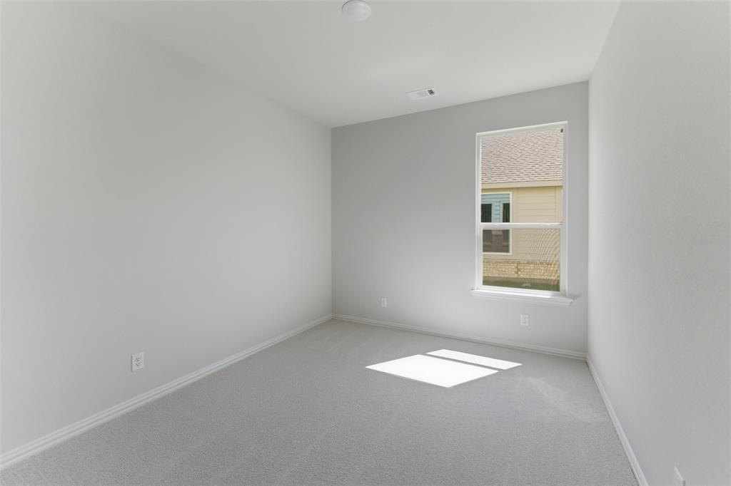 1221 Sabine River Lane Springtown, TX 76082 - Photo 13 of 25 Empty room featuring light colored carpet and baseboards