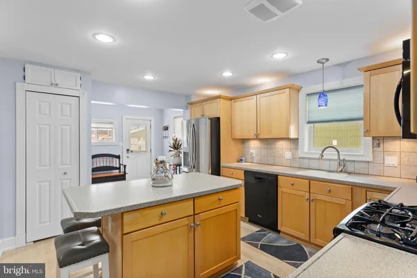 a kitchen with stainless steel appliances a sink stove and refrigerator