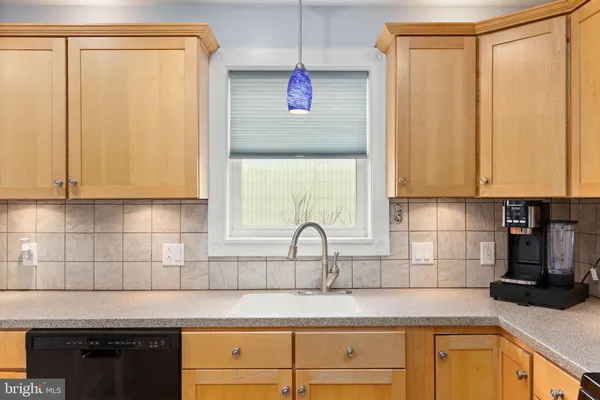 a kitchen with stainless steel appliances granite countertop a sink a stove and white cabinets