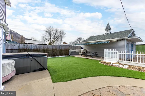 a backyard of a house with table and chairs
