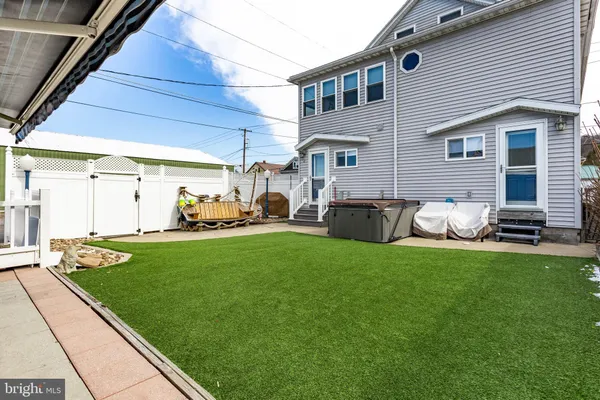 a backyard of a house with table and chairs