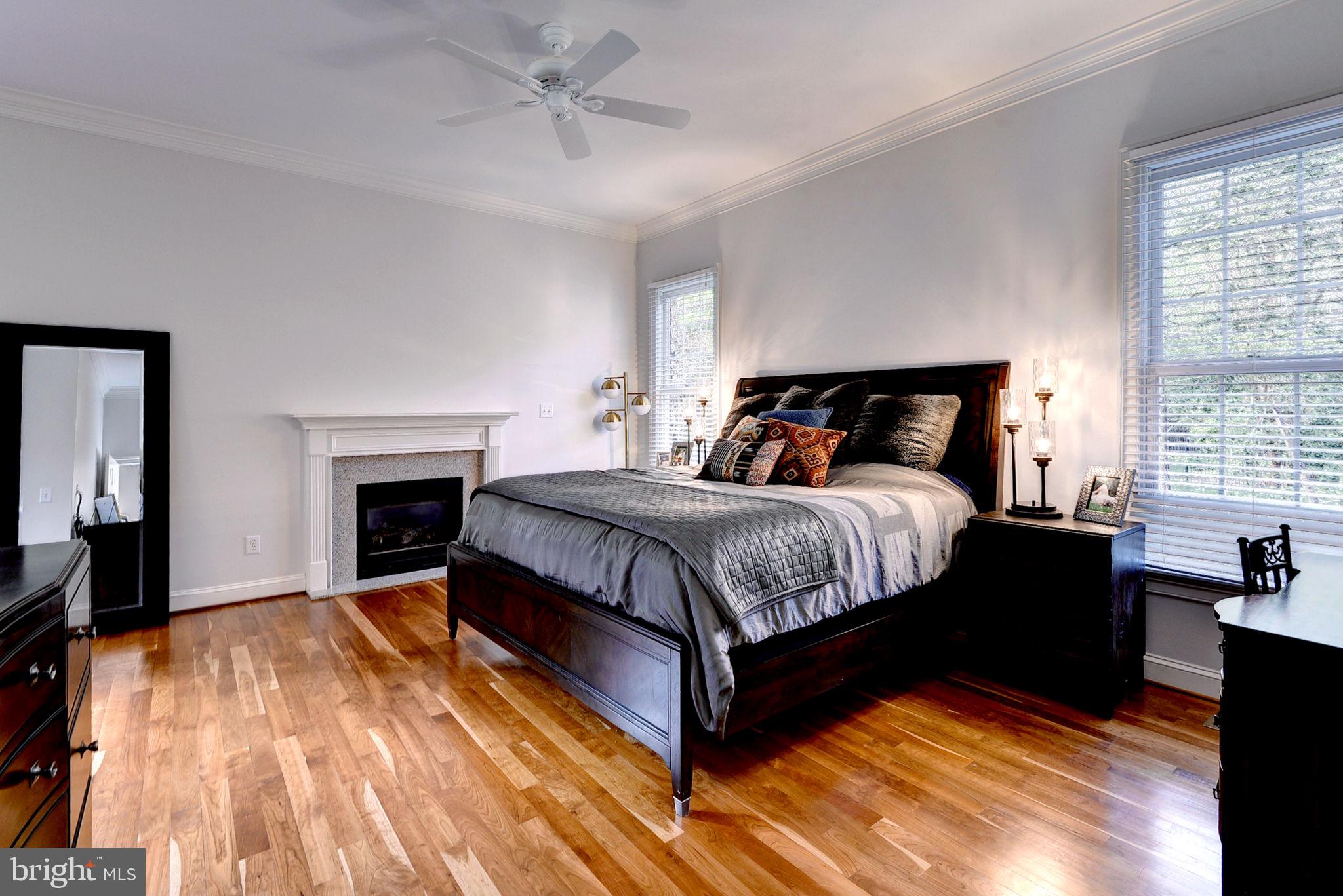 2076 Harpers Mill Road Williamsburg, VA 23185 - Photo 19 of 63 a spacious bedroom with a bed and a fireplace