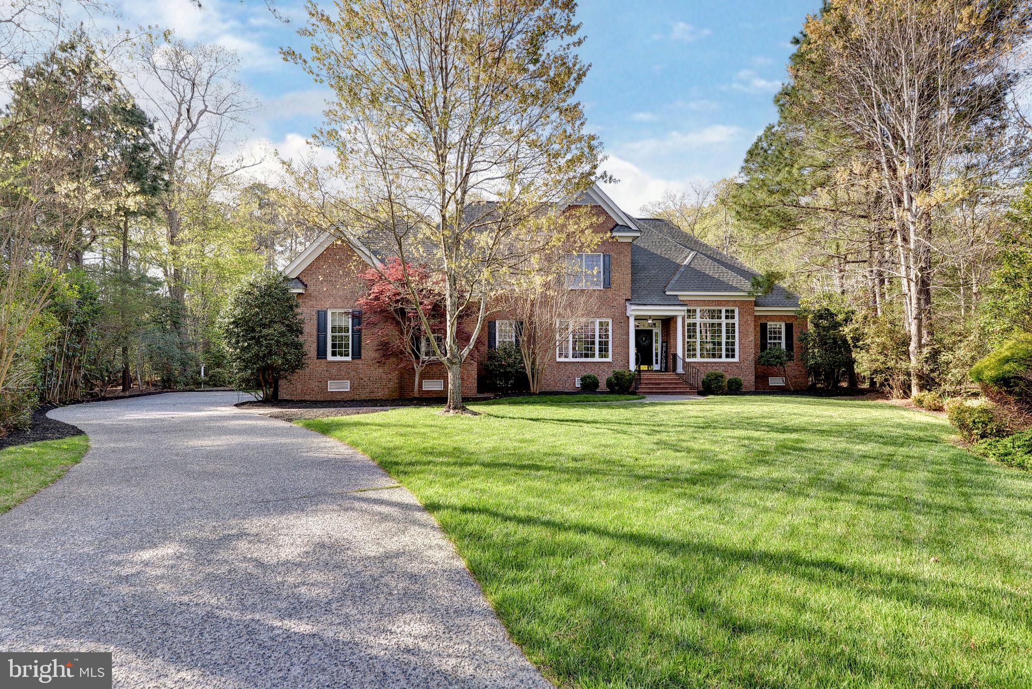 2076 Harpers Mill Road Williamsburg, VA 23185 - Photo 2 of 63 a front view of a house with a garden