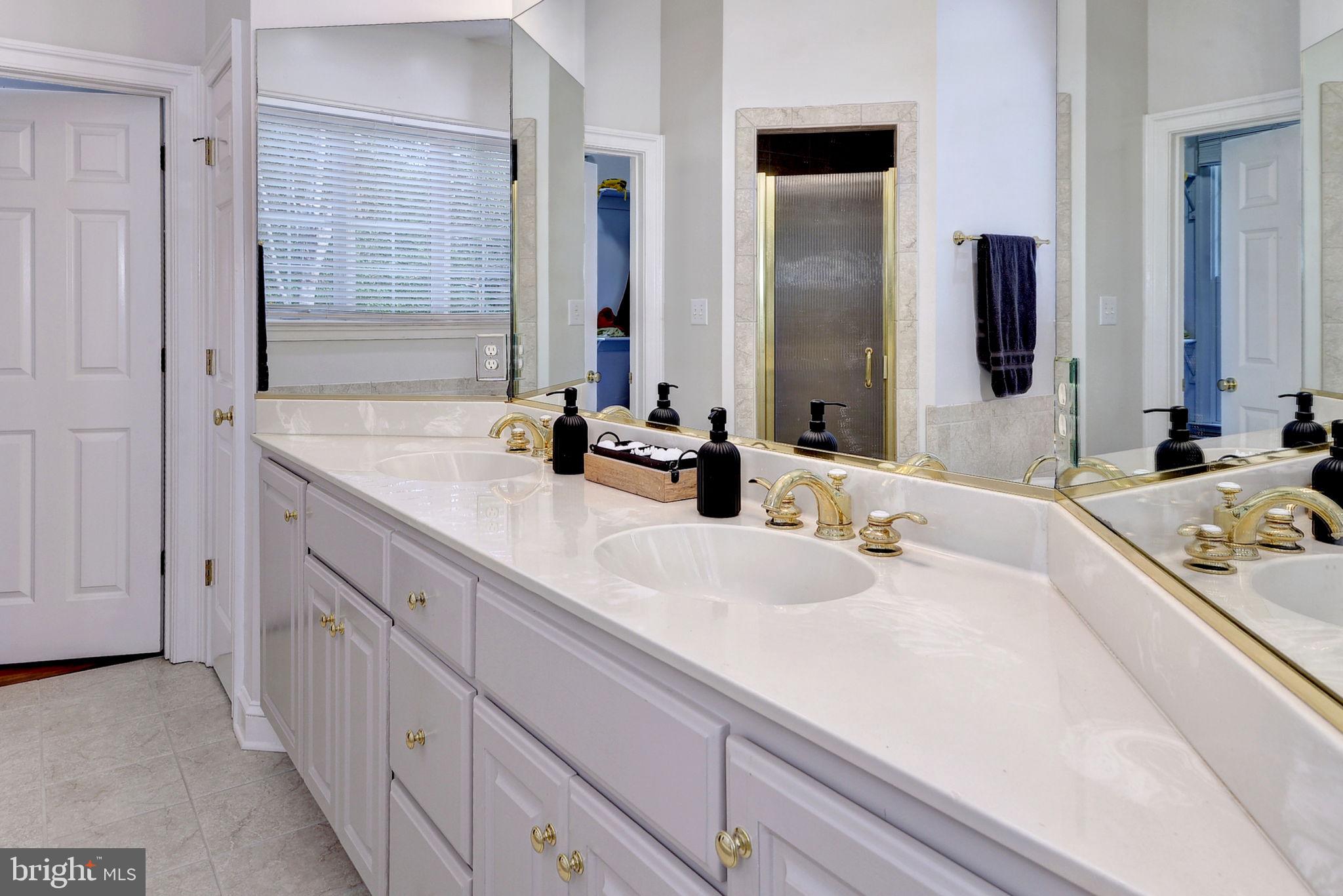 2076 Harpers Mill Road Williamsburg, VA 23185 - Photo 24 of 63 a bathroom with double vanity sinks and a mirror