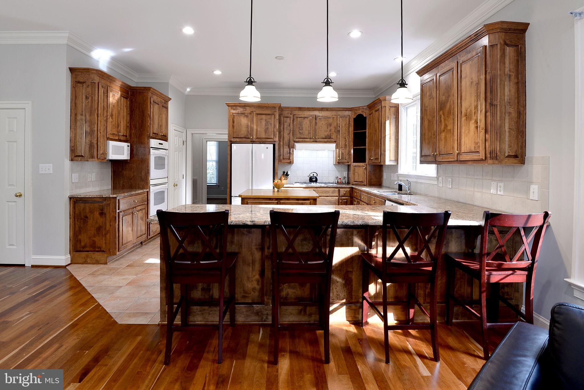2076 Harpers Mill Road Williamsburg, VA 23185 - Photo 29 of 63 a large kitchen with a table and chairs