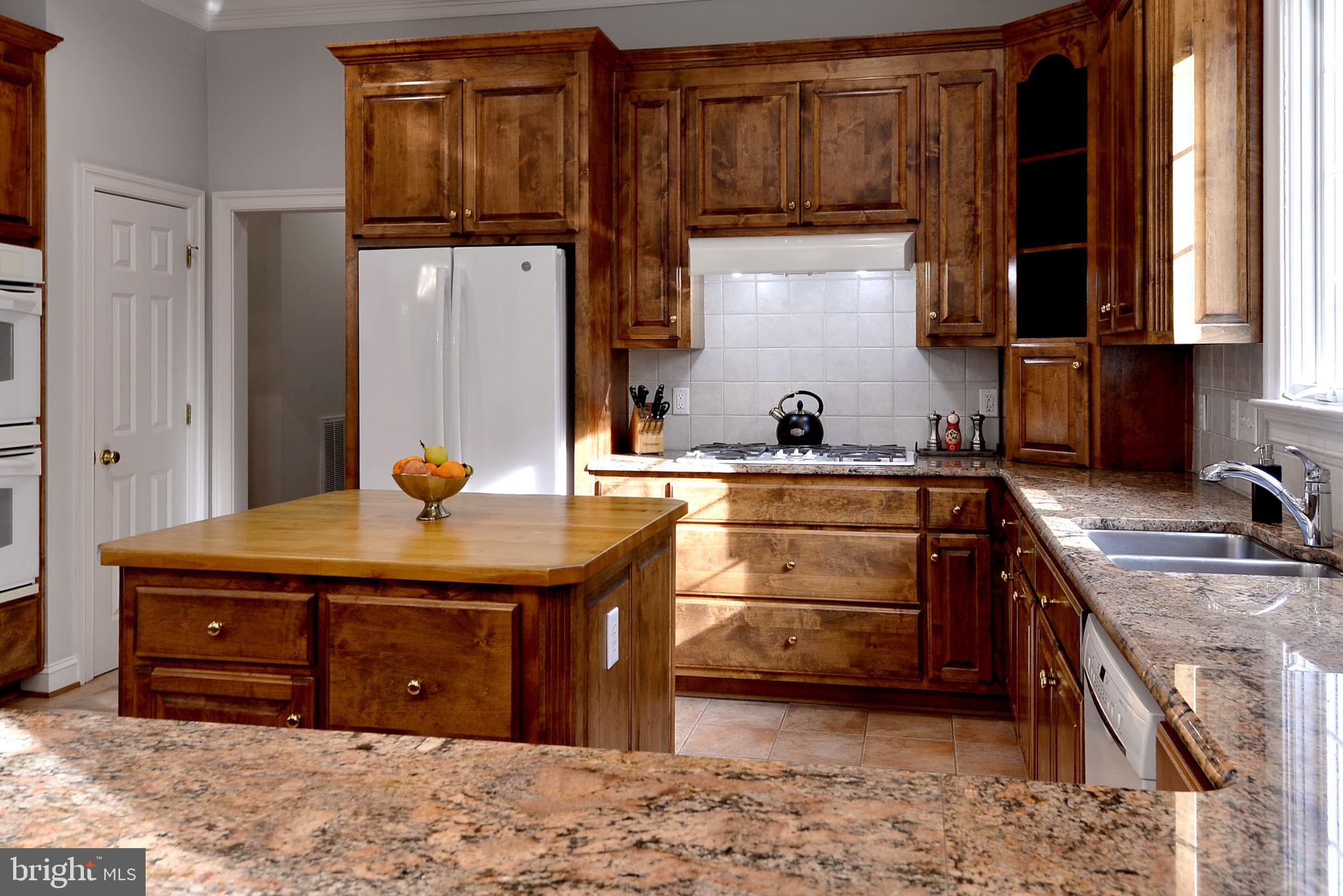 2076 Harpers Mill Road Williamsburg, VA 23185 - Photo 30 of 63 a kitchen with stainless steel appliances granite countertop a sink stove and cabinets