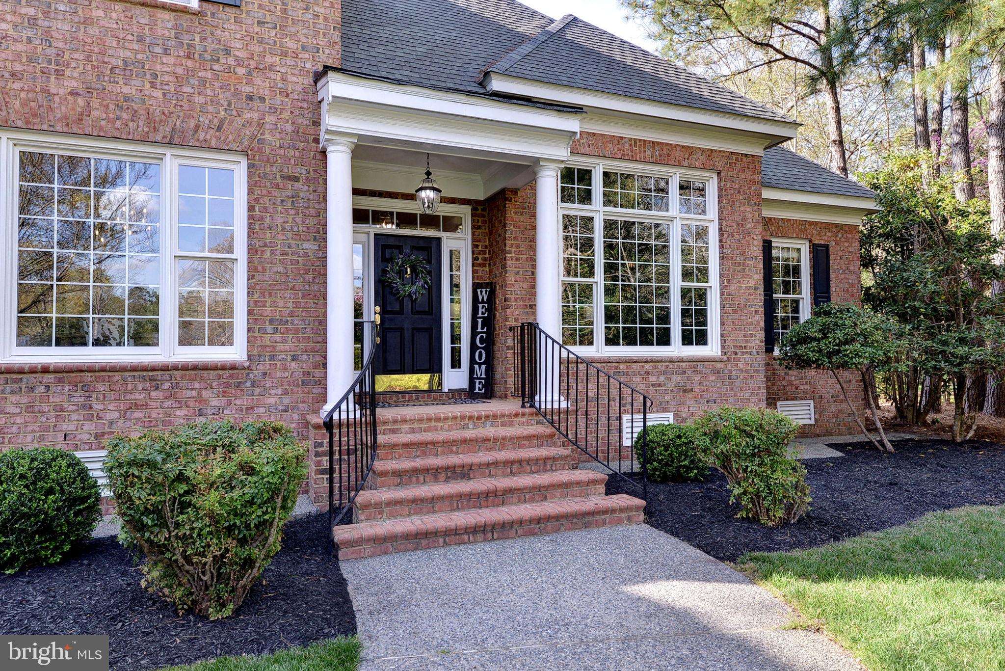2076 Harpers Mill Road Williamsburg, VA 23185 - Photo 3 of 63 a front view of a house with a garden
