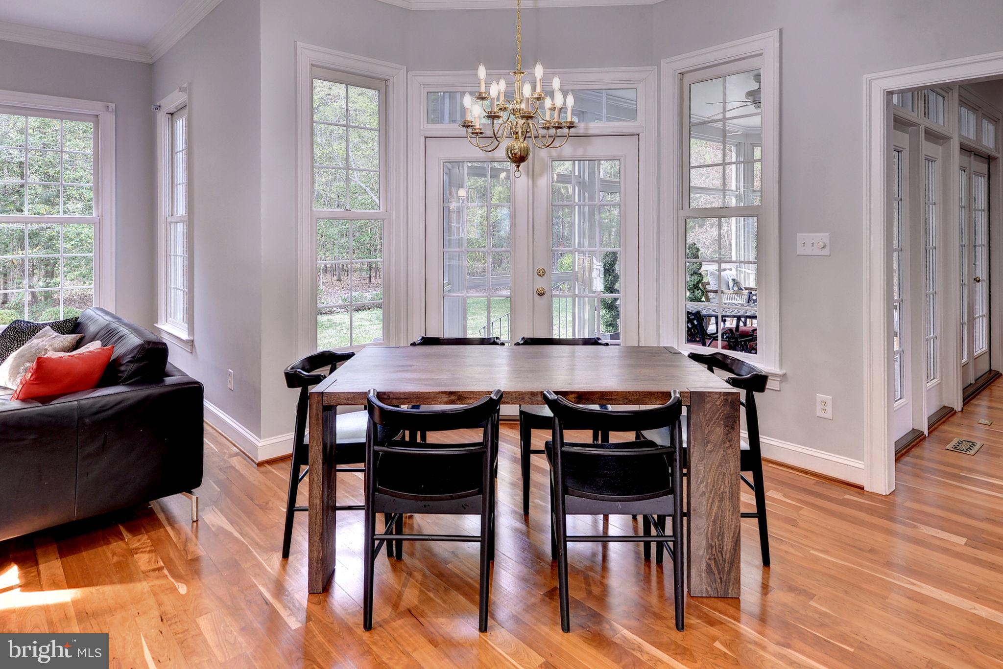 2076 Harpers Mill Road Williamsburg, VA 23185 - Photo 31 of 63 a view of a dining room with furniture window and wooden floor