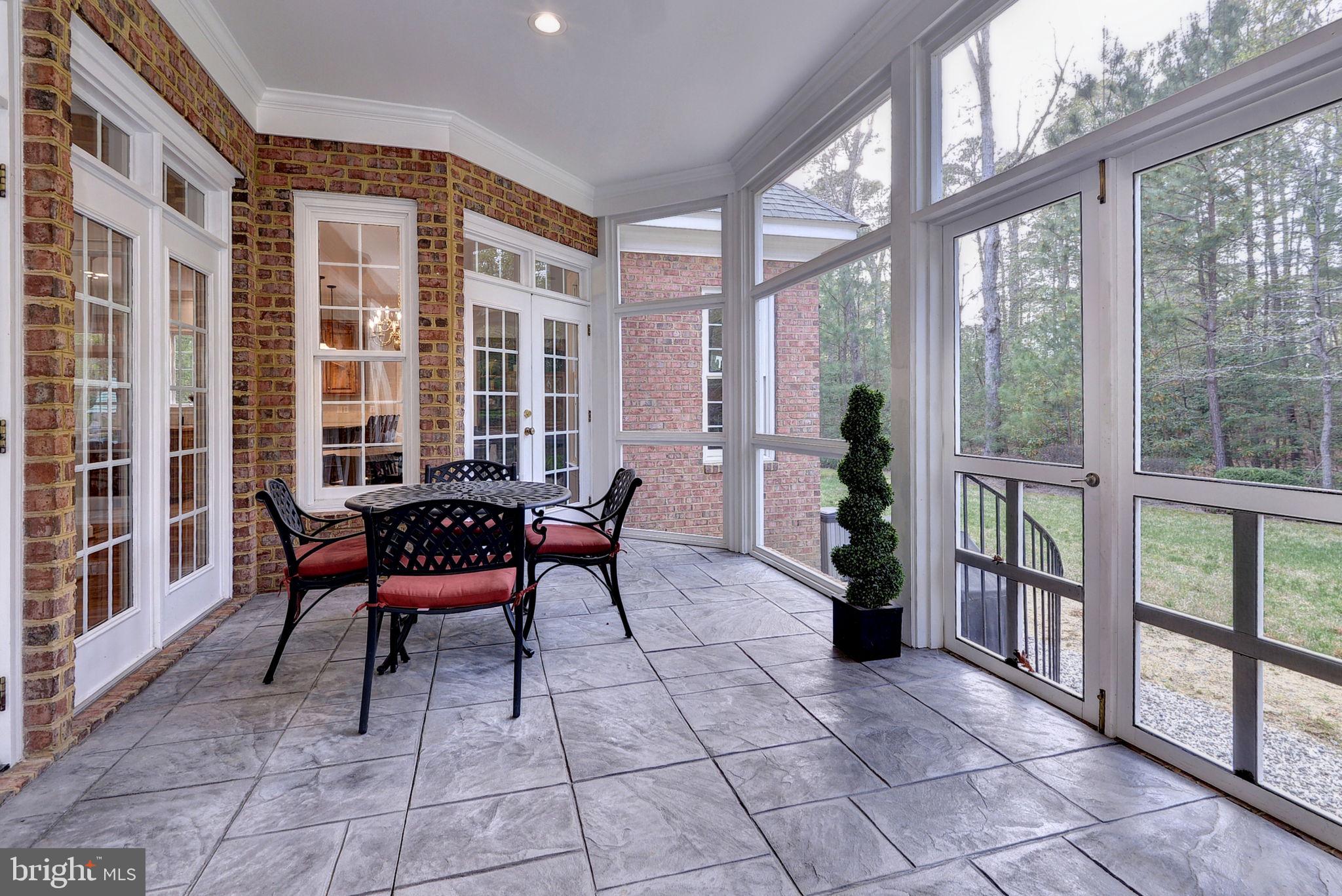2076 Harpers Mill Road Williamsburg, VA 23185 - Photo 43 of 63 a view of a porch with chairs and floor to ceiling window