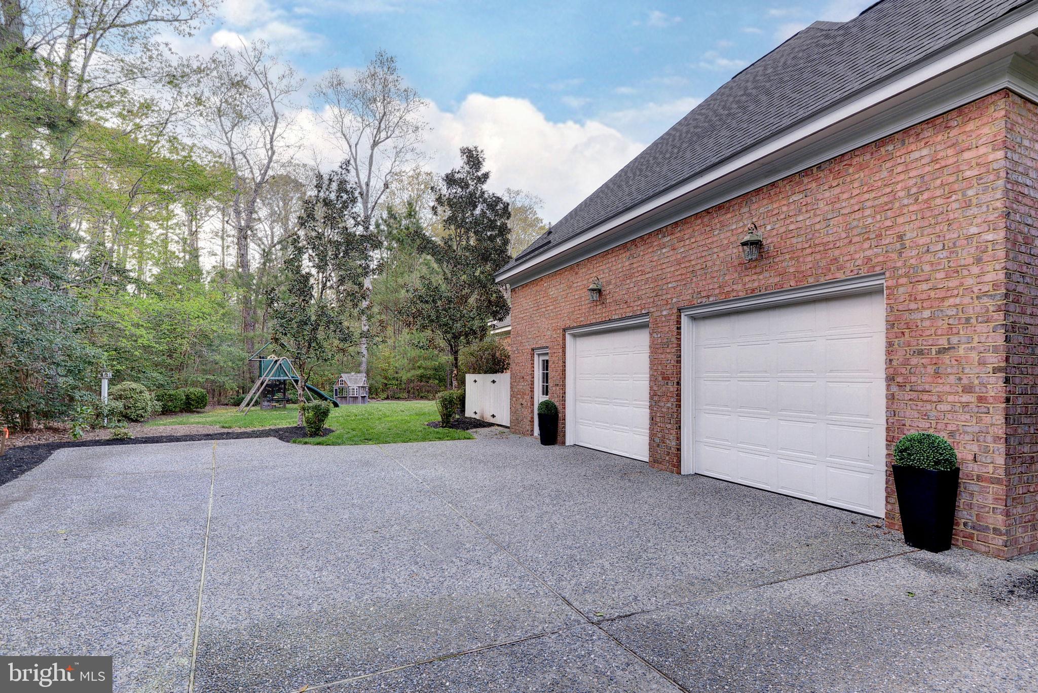 2076 Harpers Mill Road Williamsburg, VA 23185 - Photo 44 of 63 a view of a house with a backyard and bushes
