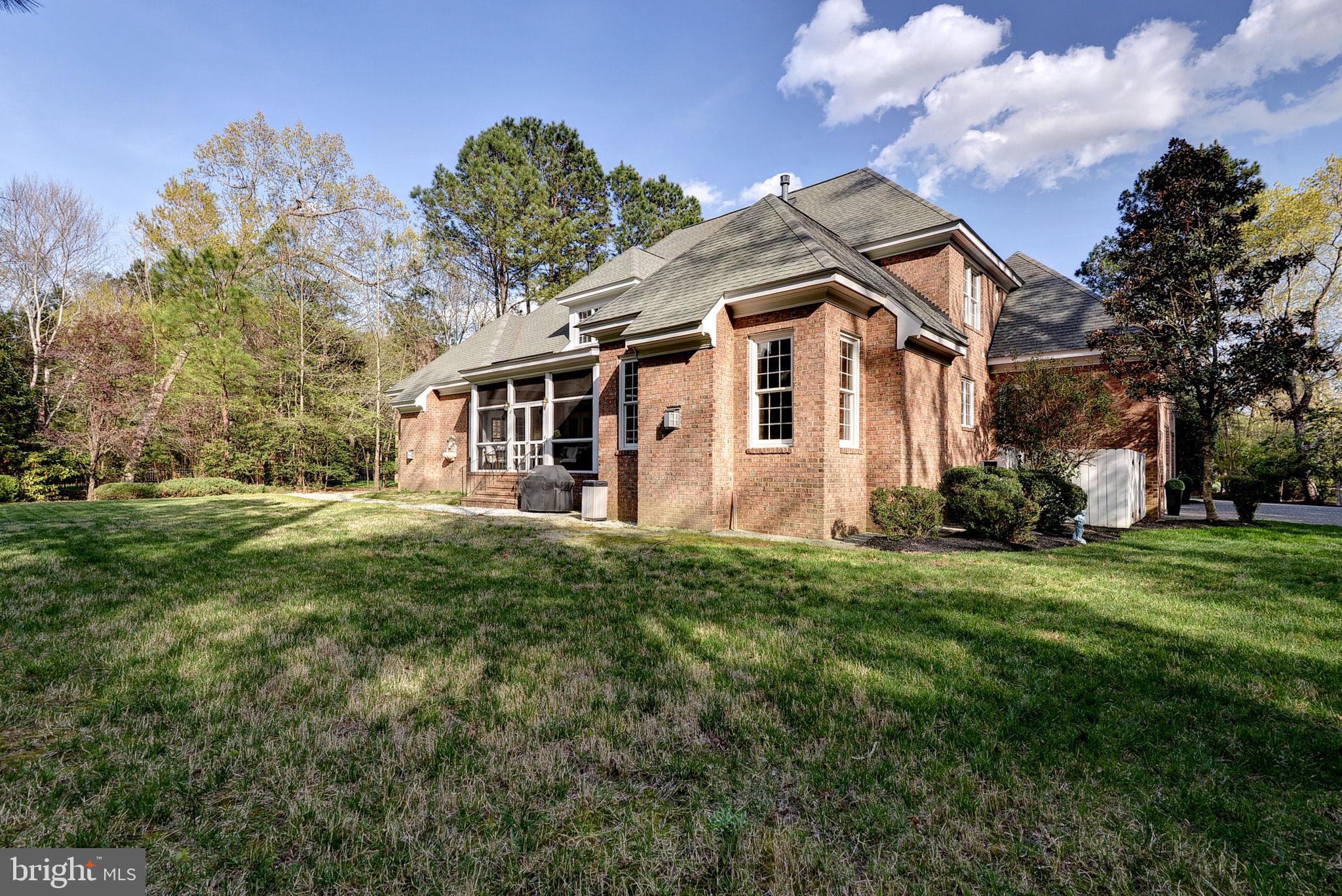 2076 Harpers Mill Road Williamsburg, VA 23185 - Photo 46 of 63 a front view of a house with a garden