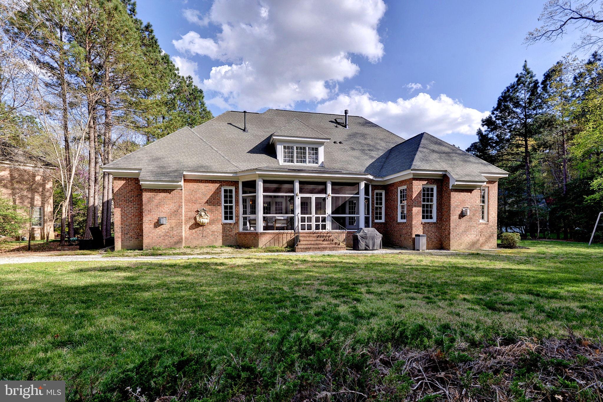 2076 Harpers Mill Road Williamsburg, VA 23185 - Photo 48 of 63 a front view of a house with a garden