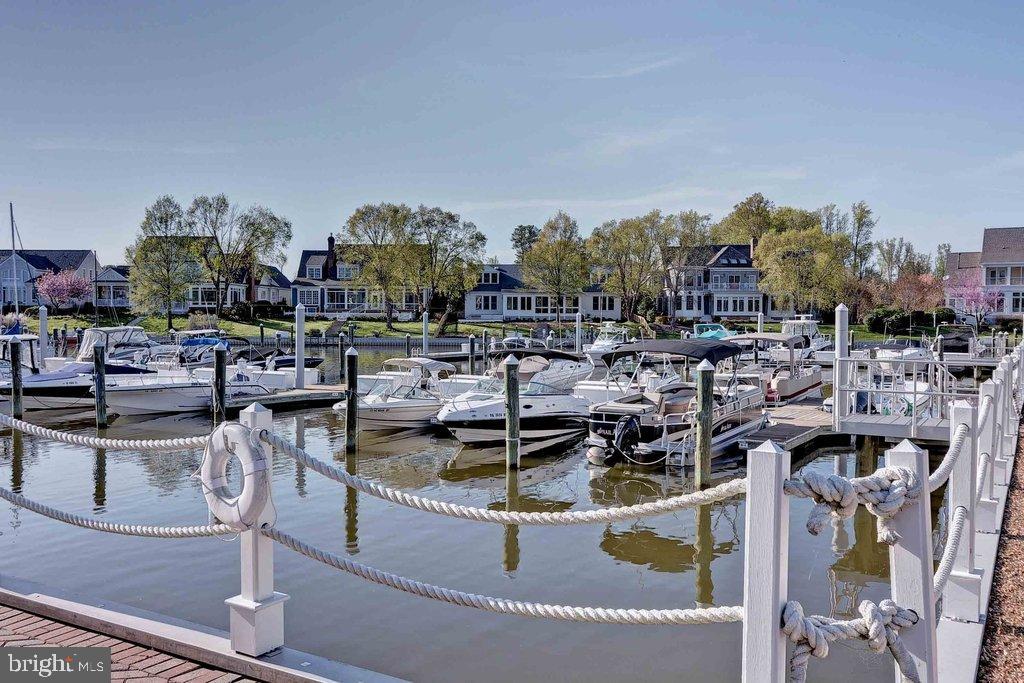 2076 Harpers Mill Road Williamsburg, VA 23185 - Photo 55 of 63 a view of a swimming pool with outdoor seating and buildings in the background