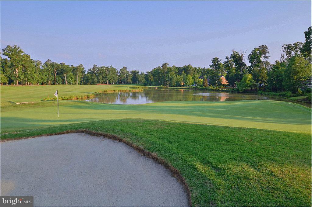 2076 Harpers Mill Road Williamsburg, VA 23185 - Photo 63 of 63 a view of a golf course with a lake