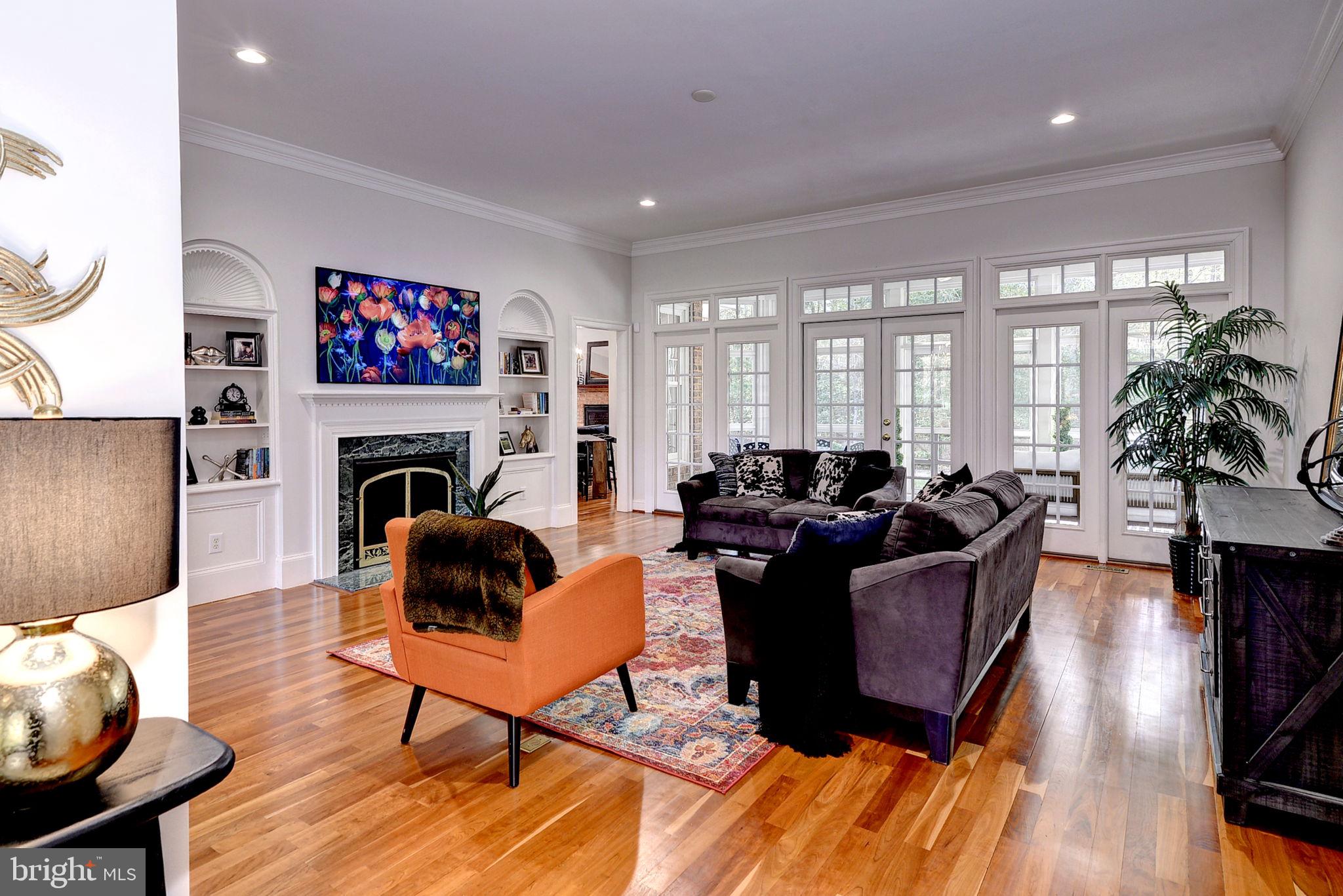 2076 Harpers Mill Road Williamsburg, VA 23185 - Photo 7 of 63 a living room with furniture a fireplace and a flat screen tv