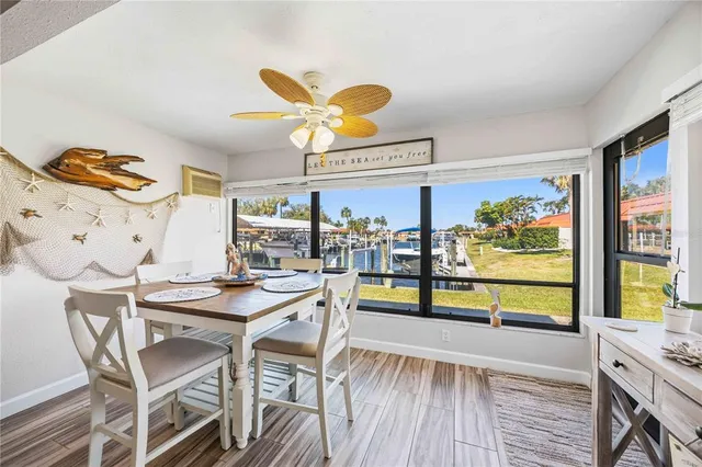 a view of a dining room with furniture large windows and wooden floor