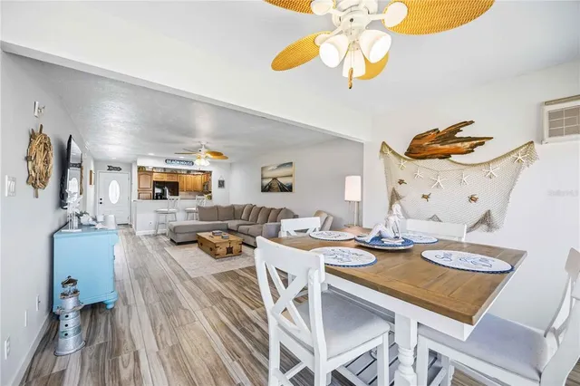 a living room with furniture a chandelier and a floor to ceiling window