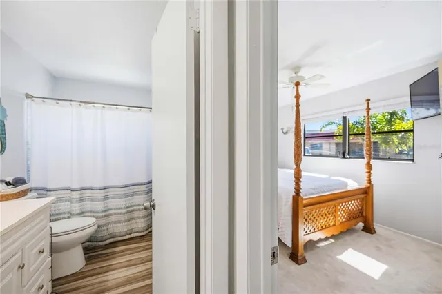 a spacious bedroom with a large bed and a flat screen tv