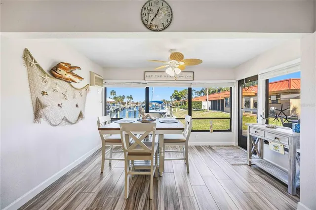 a view of a patio with table and chairs potted plants with wooden floor