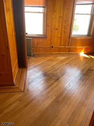 a view of a room with wooden floor and windows