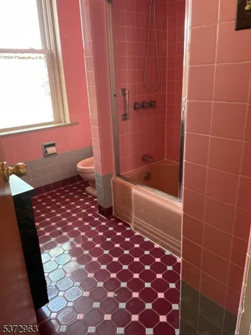 a bathroom with a toilet and a shower