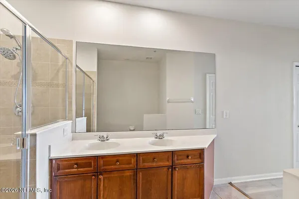 a bathroom with a double vanity sink and a mirror