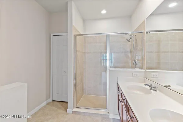 a bathroom with a sink a mirror and shower