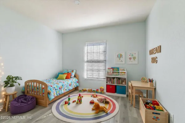 a living room with furniture and baby crib