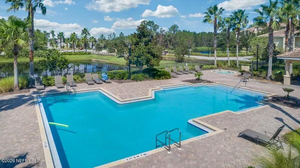 an outdoor space with pool and furniture
