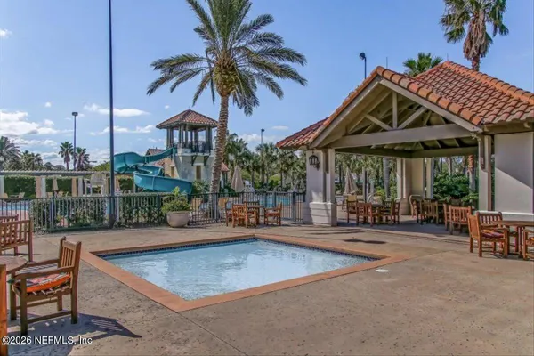 a street sign on a sidewalk next to a road