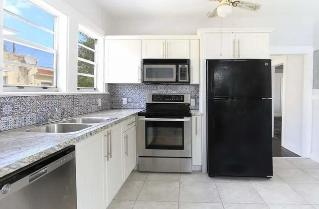 a kitchen with a refrigerator and a sink